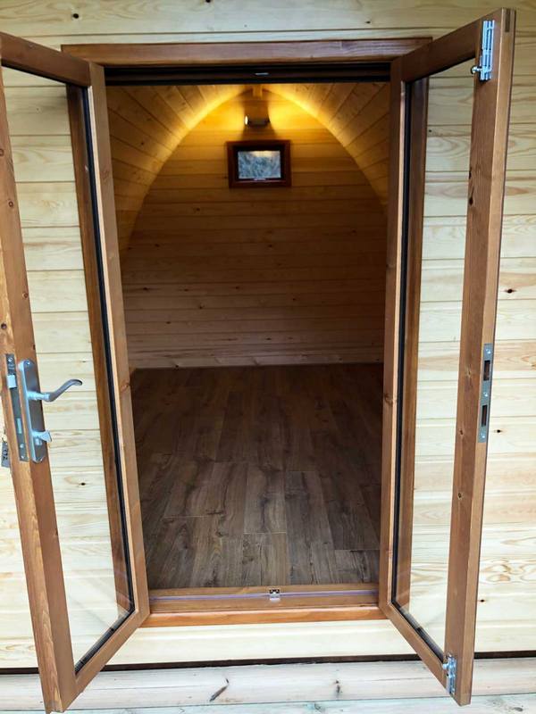 Open door looking into a camping pod