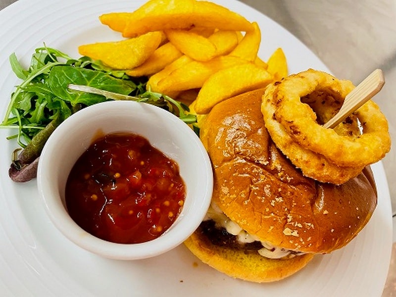 beef burger, onion rings, chips and salad